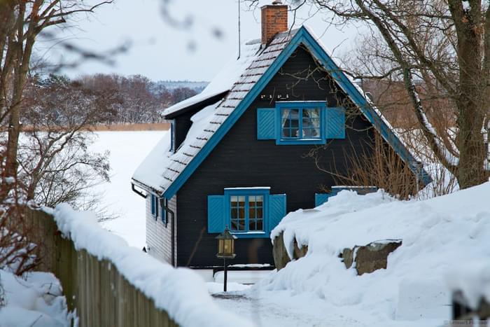 A quaint Swedish house with the frozen Baltic Sea in the background