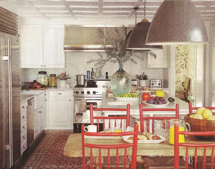 A 19th Century Caucasian runner and red chairs add a splash of color in the kitchen