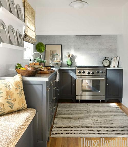 The rug and the window seat make this cottage kitchen very cozy! Since there is no center island, the designer was able to use an area size rug rather than a runner. This rug is a vintage Kilim.