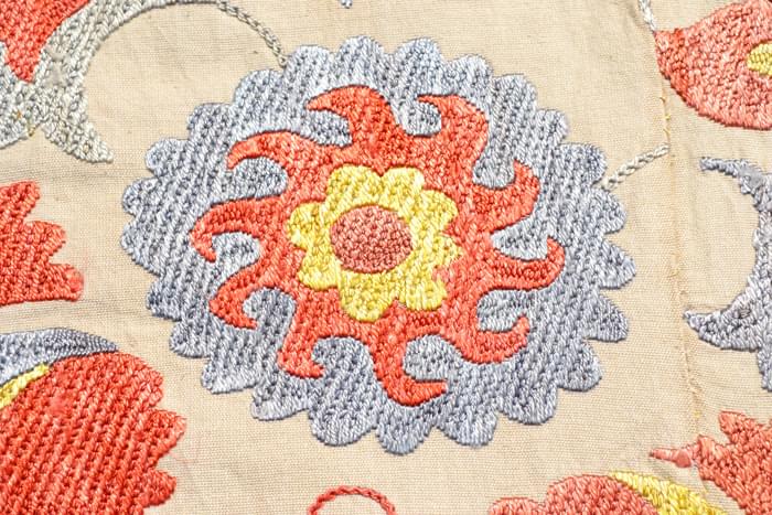 Detail of a beautiful carnation flower with accents of saffron, cochineal rust, and a pale indigo