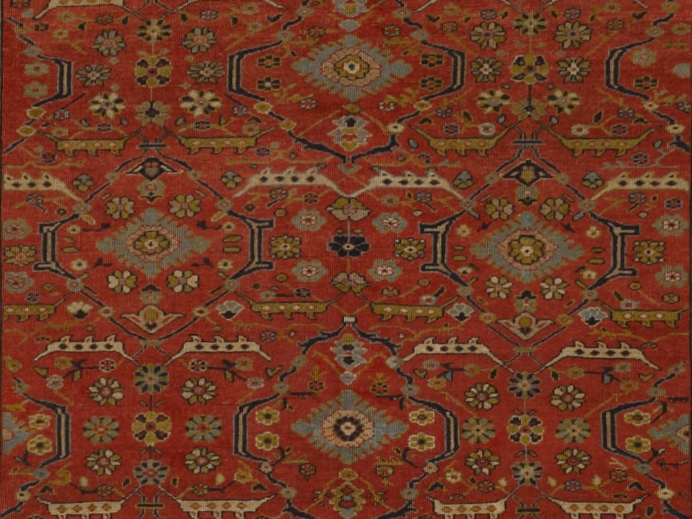 An example of a Mina Khani pattern, a particular oriental rug design, in red, gold, brown, blue, and other naturally dyed colors.