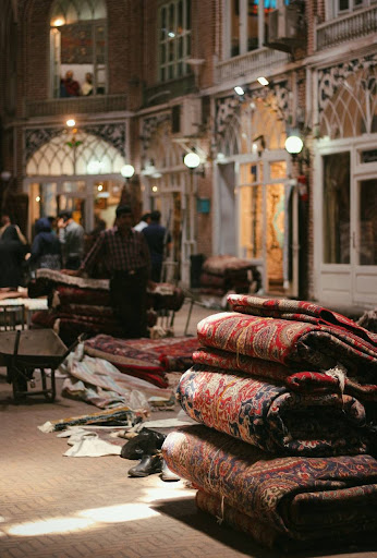 Some folded rugs in Mozffarieh row, where, at the Bazaar of Tabriz, handwoven rugs are made, exhibited, and sold.